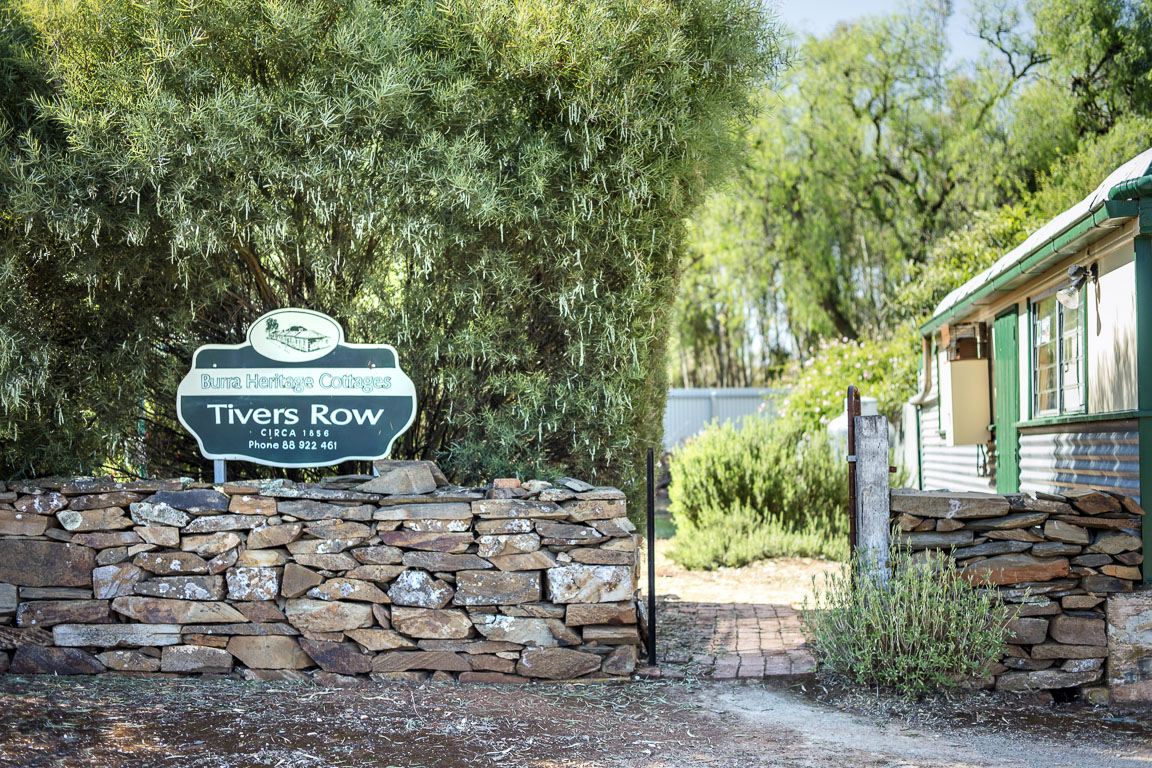 The Tivers Row stone sign at the entrance to the cottages