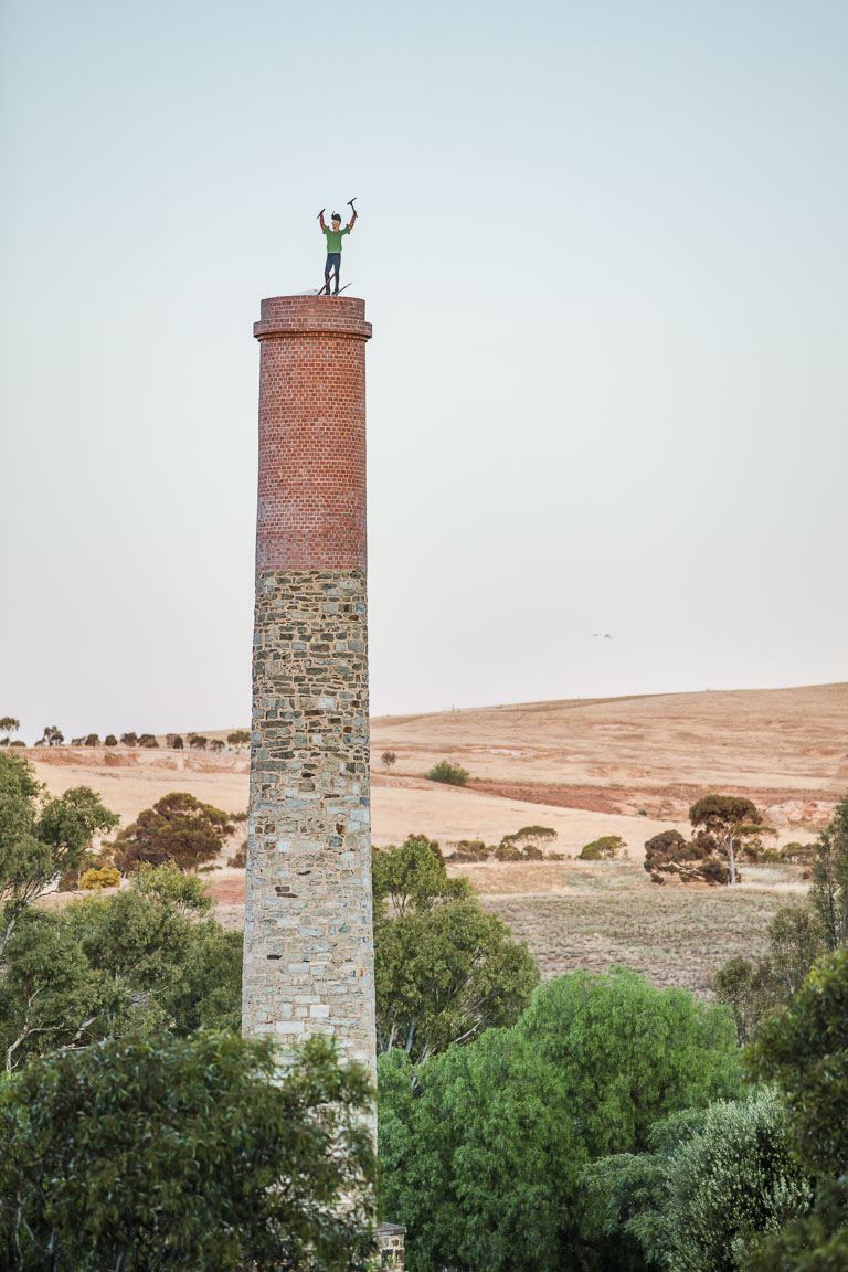 The tall brick chimney of a Cornish engine house on the ridge above Burra