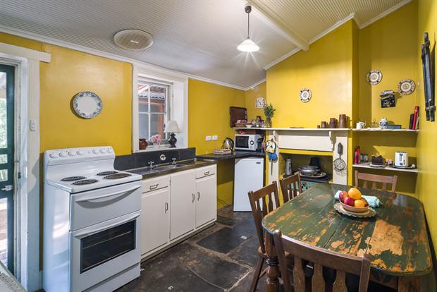 Cottage 8 — the cottage kitchen with oven, kettle and dining table
