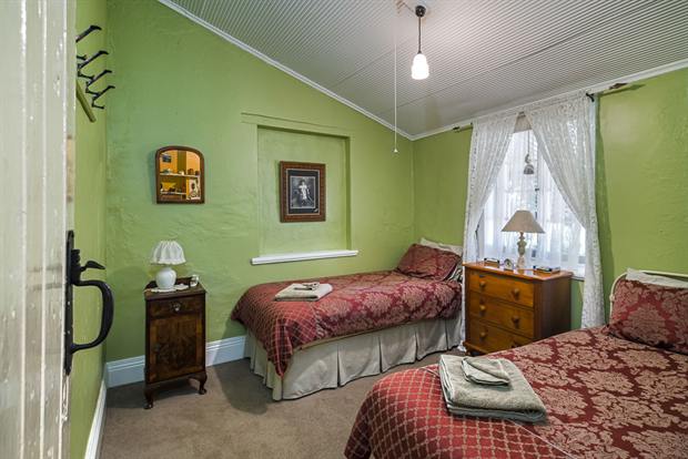 Cottage 8 — a cottage bedroom made up with linen, quilts and towels
