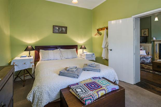 Cottage 8 — a cottage bedroom made up with linen, quilts and towels