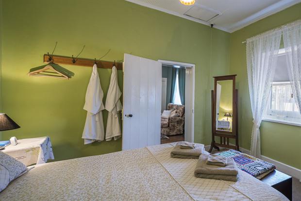 Cottage 8 — a cottage bedroom made up with linen, quilts and towels