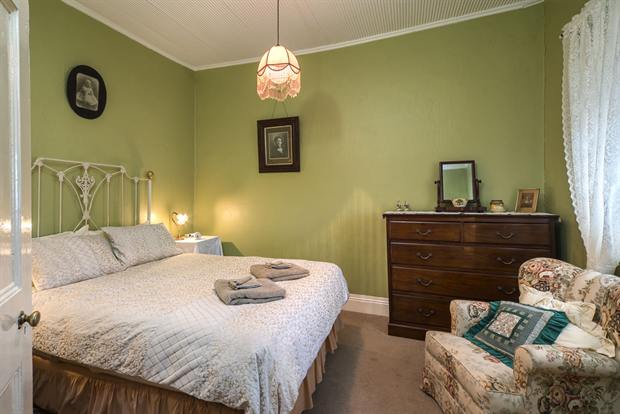 Cottage 10 — a cottage bedroom made up with linen, quilts and towels