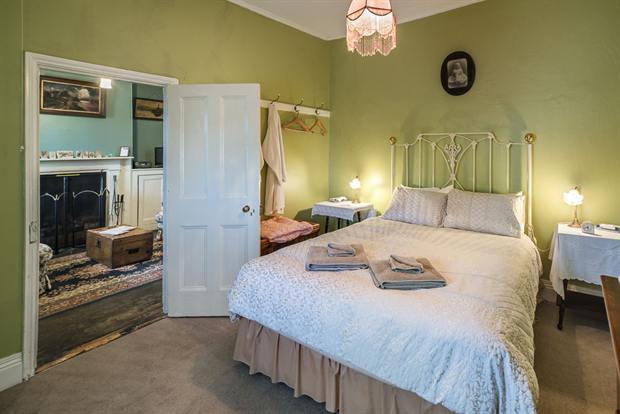 Cottage 10 — a cottage bedroom made up with linen, quilts and towels