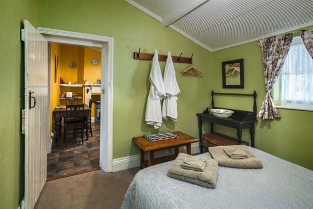 Cottage 10 — a cottage bedroom made up with linen, quilts and towels